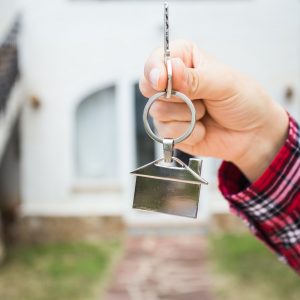 New home, house, property and tenant - Real estate agent handing a house key